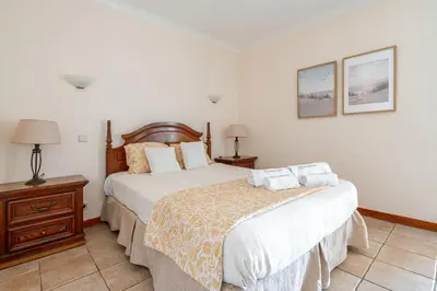 a living room with a table and a couch at Coastal Golf by Seareen in Vilamoura