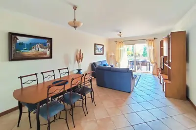 a kitchen with white cabinets and a stove top oven at Coastal Greens by Seareen in Quarteira