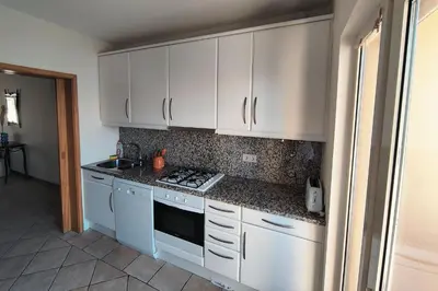 a kitchen with a door leading to a balcony at Coastal Greens by Seareen in Quarteira