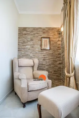 a living room with a couch and a chair and a table at #128 Number 10 Villa by Home Holidays in Albufeira