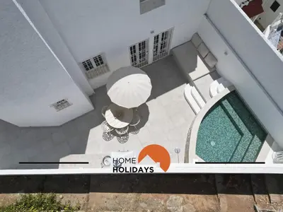 an overhead view of a house with a table and an umbrella at #128 Number 10 Villa by Home Holidays in Albufeira