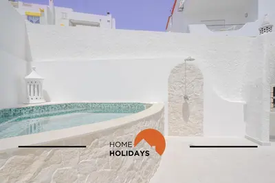 a house with a swimming pool and a sign that says home holidays at #128 Number 10 Villa by Home Holidays in Albufeira