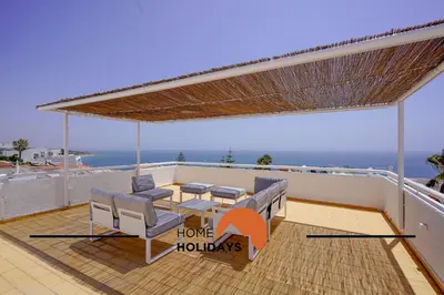 a patio with a table and chairs on a balcony at #128 Number 10 Villa by Home Holidays in Albufeira