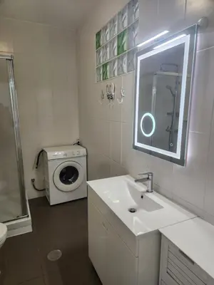 a bathroom with a sink and a washing machine at L&J Ocean View Apartment in Albufeira