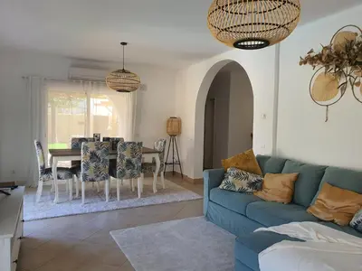 a living room with a blue couch and a table at Real Village in Quarteira