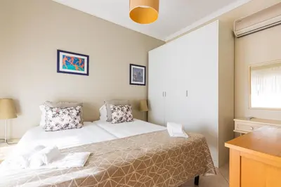 a small bedroom with a bed and a window at Casa Colina in Albufeira