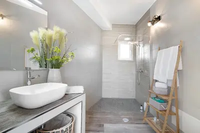 a bathroom with a white sink and a shower at Villa Flora in Algoz