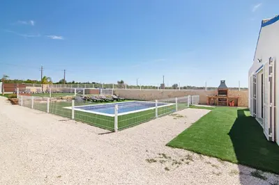 a swimming pool with a fence in a yard at Villa Flora in Algoz