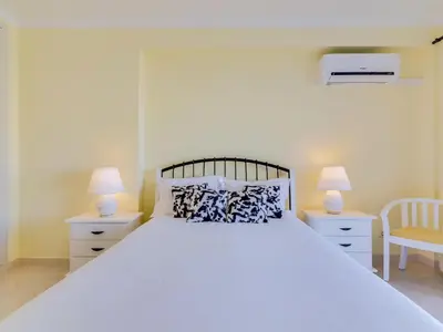 a bedroom with a large white bed with two lamps at AL - Apartamento Falésia Terrace in Vilamoura