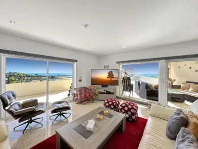 a living room with a view of the beach at Luxury Penthouse wStunning Sea Views, walk to Galé Beach Albufeira in Albufeira
