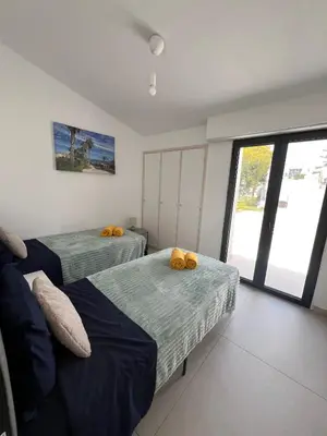 a bedroom with two beds and a window at Vilamoura Marina Villa in Vilamoura