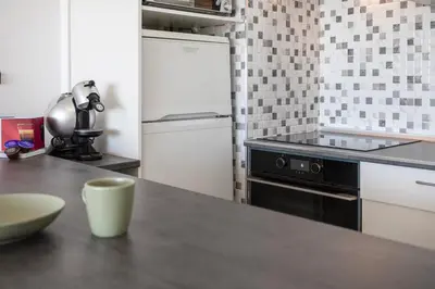 a kitchen with a counter top and a refrigerator at Quarteira SeaViews in Quarteira