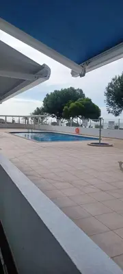 a view of a swimming pool with trees in the background at Quarteira Apartamento T2 - Oceanides in Quarteira
