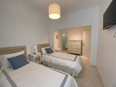 a bedroom with two beds and a dresser at Guest House in Faro