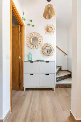 a hallway with a white dresser and two mirrors at Casinha da Jade in Albufeira
