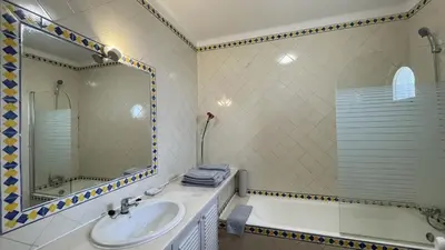 a bathroom with a sink and a tub and a mirror at Solar by Check-in Portugal in Albufeira