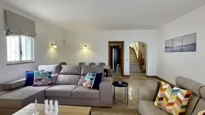 a living room with a couch and a table at Solar by Check-in Portugal in Albufeira