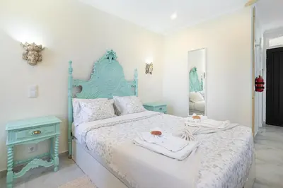 a bedroom with a blue and white bed and a mirror at Sea & Oldtown View in Albufeira