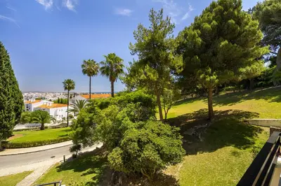 a view of a park with trees and a street at Sea & Oldtown View in Albufeira