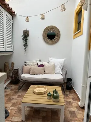 a living room with a couch and a table at Birdy House in Faro