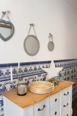 a kitchen with blue and white tiles on the wall at Birdy House in Faro